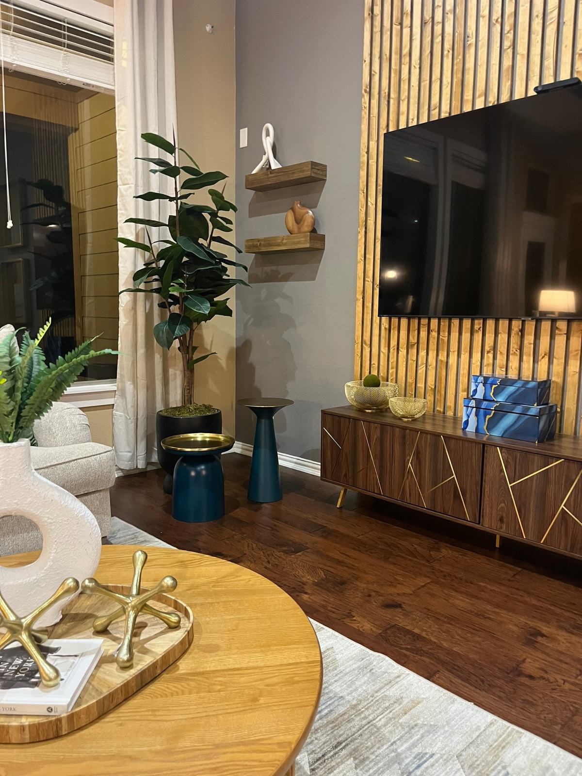Living room with wood slat TV wall and styled console